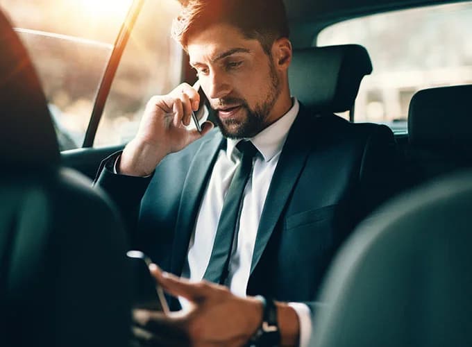 Man travelling in a booked chauffuer car